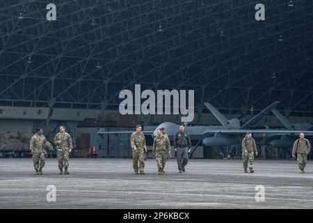 Am Kanoya Air Base, Japan, am 23. Februar 2023, gehen die Flieger vor dem MQ-9 Reaper. Die Führer des 374. Luftwaffenflügels und des 432. Luftwaffenflügels besuchten das 319. Aufklärungsgeschwader der Expedition, um sich mit den Airmen zu treffen und ihnen für ihre Arbeit bei der Wartung und dem Betrieb des MQ-9 Reaper-Flugzeugs der Staffel und für den Aufbau von Beziehungen zu ihren JMSDF-Partnern und den lokalen Japanern zu danken Gemeinschaft. Das 319. ERS MQ-9s unterstützt die Prioritäten der japanischen und US-amerikanischen Nachrichtendienste, Überwachung und Aufklärung im gesamten Indo-Pazifik und sendet die erfassten Informationen an die BILAT Stockfoto