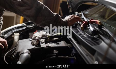 Hände des Automechanikers. Schutzhandschuhe und -Werkzeuge. Auto-Service. Fahrzeugreparatur und -Wartung. Stockfoto