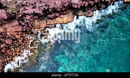 Ein malerischer Blick auf eine felsige Küste mit großen Steinen und Felsbrocken Stockfoto