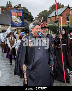 Eine Gruppe von Steampunken, die in einer Prozession entlang einer Straße laufen. Stockfoto