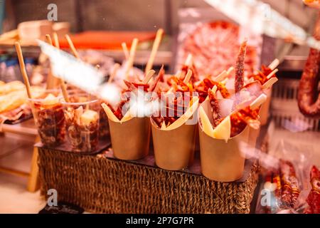 Traditioneller spanischer Chorizo, Jamon und Käsesnacks zum Mitnehmen auf dem berühmten Markt in Barcelona, Katalonien, Spanien. Stockfoto