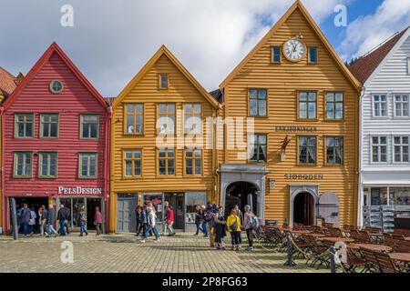 Touristen genießen Norways Meistbesuchte Touristenattraktion Bryggen. Bryggen ist eine Reihe alter hanseatischer Geschäftsgebäude und gehört zum UNESCO-Weltkulturerbe Stockfoto