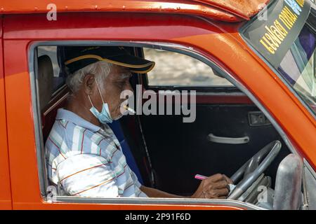 SAMUT PRAKAN, THAILAND, MÄRZ 06 2023, ein älterer Mann raucht eine Zigarette, während er ein Auto fährt und in einem Stau steht Stockfoto