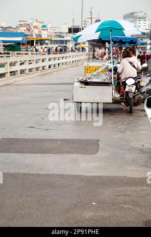 Pattaya, Thailand - 28. März 2016: Lebensmittelverkäuferin auf einem motorisierten Wagen, das geschälte Ananas verkauft. Street Food an einer Straßenseite in einer asiatischen Stadt Stockfoto