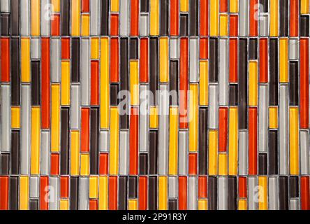 Colorful glass vertical rectangular tiled wall background: yellow, red, white, black pattern. Multicolor tiles Stockfoto