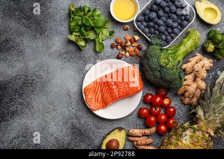 Entzündungshemmendes Diätkonzept. Eine Auswahl an Lebensmitteln, die helfen, Entzündungen zu reduzieren – pflanzliche Zutaten, frisches Obst, grünes Gemüse. Gesunde Ernährung Stockfoto