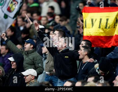 ** ADVANCE FOR TUESDAY, FEB. 10, AND THEREAFTER *** Real Madrid fans cheer on their team against Racing de Santander during a Spanish La Liga soccer match at the Santiago Bernabeu stadium in Madrid, Saturday Feb. 7, 2009. Spain is a serious contender to host the 2016 Olympics and 2018 World Cup, but a failure to clamp down on racist and extremist fan behavior could end up compromising both bids. (AP Photo/Paul White)
