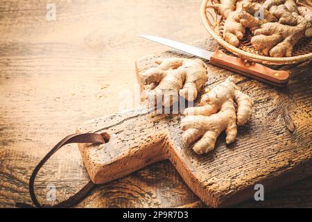 Frische organische Ingwerwurzeln auf Holzhintergrund. Stockfoto