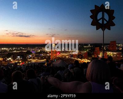 Blick vom Park aus auf das Glastonbury Festival 2022 bei Sonnenuntergang Stockfoto