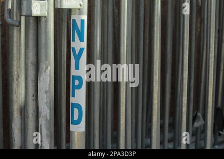 Metallbarren aus Menschenmassen kontrollieren die Polizeibarrikaden in New York City mit NYPD-Logo-Design Stockfoto