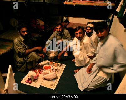 ** FOR STORY SLUGGED DUBAI TRABAJADORES ** Pakistani labors prepare for their dinner in their room at a labor camp in Dubai, United Arab Emirates, Feb. 22, 2008. (AP Photo/Kamran Jebreili)