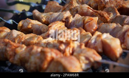 Nahaufnahme mehrerer saftiger Fleischkebabs, die auf dem Grill im Barbecue gekocht wurden. Stockfoto