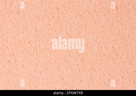 Einfacher, leicht orangefarbener, cremiger, pinkfarbener Ethylenvinylacetat-Schaum mit Schaumstoffstruktur. Hochauflösende Fotostruktur des Materials. Stockfoto