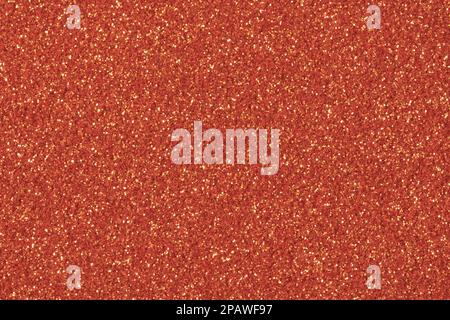Orangefarbener Glitzer. Hintergrund für Ihr Design. Kontrastarmes Foto. Perfektes, wunderschönes Retro-texturiertes Material im Vintage-Stil. Stockfoto