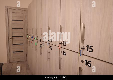Viele nummerierte Schließfächer aus Holz mit Schlüsseln im Innenbereich Stockfoto