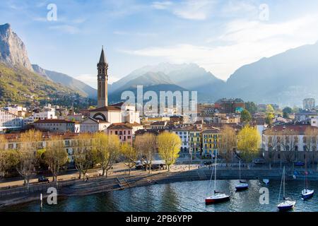 Sonniges Stadtbild von Lecco am Frühlingsmorgen. Malerische Uferpromenade der Stadt Lecco zwischen dem berühmten Comer See und den malerischen Bergamo-Alpen Stockfoto