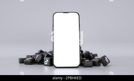 3D-Rendering von Mobiltelefonen mit leerem Bildschirm und tiktok-Logos hinter isoliertem grauem Hintergrund Stockfoto