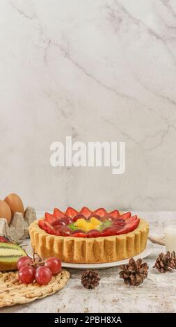 Großer Obstkuchen mit Erdbeeren, Trauben, Kiwi und Ananas. Herzhaft, süß und frisch. Konzeptfoto für Speisen. Stockfoto