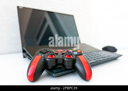 Arbeitsraumkonzept für Gamer, Spielausrüstung mit Draufsicht, Maus, Tastatur, Joystick und Headset auf weißem Tischhintergrund. Stockfoto