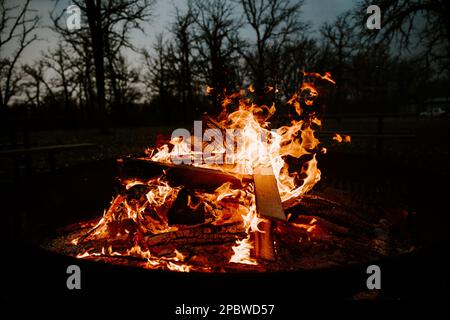 Knisterndes Lagerfeuer mit Funken an einem dunklen Abend Stockfoto