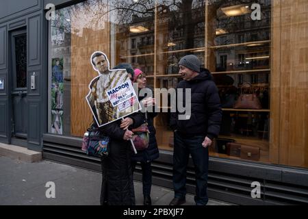 Michael Bunel / Le Pictorium - Demonstration gegen die Rentenreform in Paris - 11/3/2023 - Frankreich / Paris / Paris - Ein Demonstrante trägt ein Plakat mit einem Porträt von Präsident Emmanuel Macron in königlicher Kleidung. Auf dem Plakat steht, Macron, Missachtung der Republik. Diese Zeichen wurden von der Kommunistischen Partei Frankreichs (PCF) verteilt. Siebter Tag der Mobilisierung gegen die Rentenreform und die Änderung des Rentenalters. Bei der Demonstration kamen laut Innenministerium in ganz Frankreich 368.000 Demonstranten zusammen, darunter 48.000 in Paris. Stockfoto