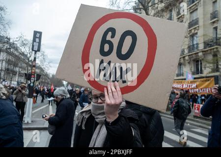 Michael Bunel / Le Pictorium - Demonstration gegen die Rentenreform in Paris - 11/3/2023 - Frankreich / Paris / Paris - Ein Demonstrante hält ein Zeichen, das vom Spiel "le mille Borne" inspiriert ist. Max. 60 wird in einem roten Kreis geschrieben. Siebter Tag der Mobilisierung gegen die Rentenreform und die Änderung des Rentenalters. Bei der Demonstration kamen nach Angaben des Innenministeriums in Frankreich 368.000 Demonstranten zusammen, darunter 48.000 in Paris. Die CGT zählte mehr als eine Million Demonstranten, darunter 300.000 in Paris. 11. März 2023 Paris, Frankreich. Stockfoto