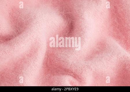 Nahaufnahme eines weichen rosa Angora-Stoffes, Textildetails in Pastelltönen Stockfoto