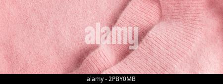 Nahaufnahme eines weichen rosa Angora-Stoffes, Textildetails in Pastelltönen Stockfoto