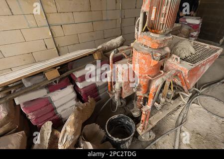 Ein spezieller Mischer zum Mischen von trockenem Putz mit Wasser und zum automatischen Zuführen des fertigen Putzes. Stockfoto