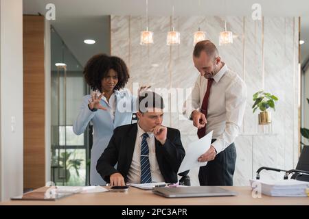 Gestresste, überwältigte Geschäftsleute fühlen sich bei einem Geschäftstreffen müde, erschöpfte Geschäftsleute leiden unter Kopfschmerzen, die Tempel im Team berühren Stockfoto