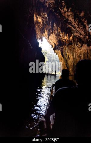 Touristen in Silhouette, die auf Bambusflößen in den dunklen Tunnel des Flusses in den Höhlen von Tham Nam Lod, Provinz Mae Hong Son, Thailand, gefährt wurden. Stockfoto