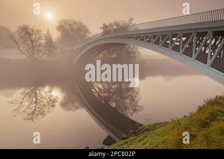 Blick auf den Fluss und die gusseiserne Straßenbrücke im Morgennebel, Bigsweir, River Wye, Wye Valley, an der Grenze zu Gloucestershire, England, Monmouthshire, Wales, Uno. Stockfoto