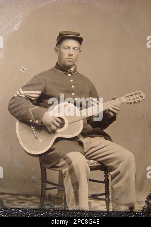 Edwin Chamberlain von Kompanie G, 11. New Hampshire Infanterie-Regiment in Sergeant-Uniform mit Gitarre. Liljenquist Family Sammlung von Bürgerkriegsfotografien , Veröffentlicht in: Militärbilder. HENRYVILLE, Pa, Januar-Februar 1998 (XIX, 4), S. 7, Ausgestellt in der Library of Congress, Washington, D.C., 2011, pp/liljunion. Chamberlain, Edwin, -1864, Usa, Armee, New Hampshire Infantry Regiment, 11. (1862-1865), People, United States, History, Bürgerkrieg, 1861-1865, Militärpersonal, Union, Soldaten, U Stockfoto