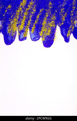 Auf weißem Hintergrund, blaue schillernde Flecken von fließender Acrylfarbe mit Goldglitzern. Stockfoto