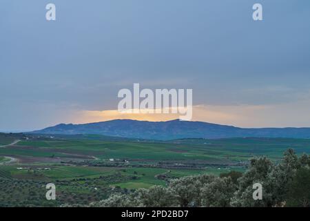 Berg bei Sonnenuntergang an einem regnerischen Tag Stockfoto