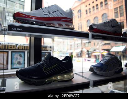 Nike Air Max 360 running shoes share shelf space with other models on a display near a windown in the Niketown in downtown Denver on Tuesday March 21 2006. Nike will post