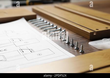 Komposition mit Möbelteilen und Werkzeugen zur Selbstmontage auf Holzhintergrund, Nahaufnahme Stockfoto