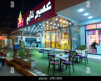 Falluja, Irak - 27. Februar 2027: Landscape Night View of Aseer Time Cafeteria. Es ist eine kuwaitische Marke mit Franchises und über 325 weltweit. Stockfoto