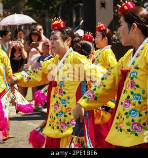 Chabarowsk, Russland - 13. August 2017: Traditionelle koreanische Tänzer. Alte Damen tragen bunte gelb und rosa Kleider, tanzen Buchaechum oder Lüfter Tanz Stockfoto