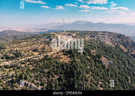 Spektakulärer Panoramablick auf einen Bergkamm, der mit der Energie von Dutzenden von Windturbinen aufragt und eine wunderschöne, atemberaubende Landschaft schafft. Stockfoto