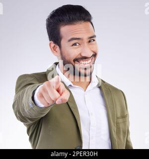 Porträt, Erfolg und asiatischer Mann, der auf dich zeigt, glücklich und fröhlich vor grauem Studiohintergrund. Face, japanischer männlicher Angestellter und Typ mit Stockfoto