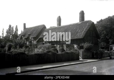 1955, historisch, Blick aus dieser Ära von Anne Hathways Hütte in Shottery, nahe Stratford upon Avon, Warwickshire, England, Großbritannien. Das Bauernhaus mit Strohdach war das Kinderhaus der Ehefrau des weltberühmten englischen Dramatikers William Shakespeare. Stockfoto