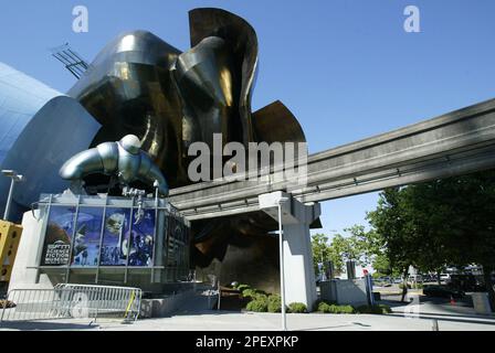 ** ADVANCE FOR WEEKEND JUNE 12-13 ** The entrance to Seattle's new Science Fiction Museum and Hall of Fame, at lower left, shares space with the Experience Music Project museum Tuesday, June 8, 2004 at the Seattle Center. The location, the shiny, twisted, futuristic building designed by Frank Gehry, in the shadow of the Space Needle and with the Monorail -- a 1960s conception of future travel -- running through it, seems appropriate for a museum that features the history of how visionaries have envisioned the future. (AP Photo/Ted S. Warren)