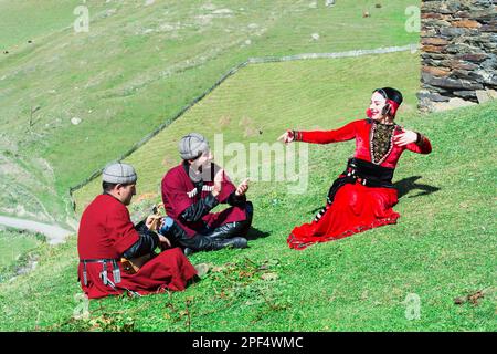 Georgier aus einer Folkloregruppe, die Panduri spielt und in traditioneller georgischer Kleidung tanzt, nur zu redaktionellen Zwecken, Ushguli, Svanetia Stockfoto