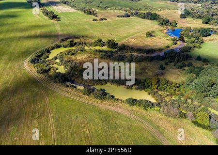 Flug über eine grüne Landschaft mit einem sumpfigen Bett des Ogublyanka-Sees, Kaluzhskiy-Region, Russland Stockfoto