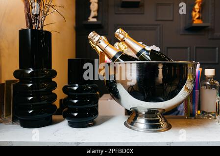 Flaschen Champagner in einem Eimer auf einer Marmorplatte Stockfoto