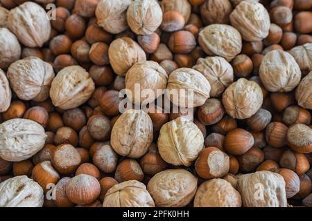 Auswahl an Muttern. Haselnüsse, Walnüsse für den Hintergrund. Essen gemischt auf Holzhintergrund, Draufsicht, Kopierbereich, Hintergrund mit Muttern, Textur Stockfoto