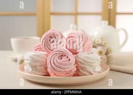 Teller mit köstlichen Marshmallows auf einem Holztisch Stockfoto