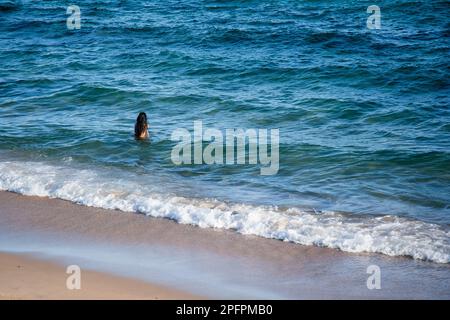 Salvador, Bahia, Brasilien - 22. Oktober 2022: Touristen baden und entspannen am Strand Farol da Barra an heißen Tagen. Salvador, Bahia. Stockfoto