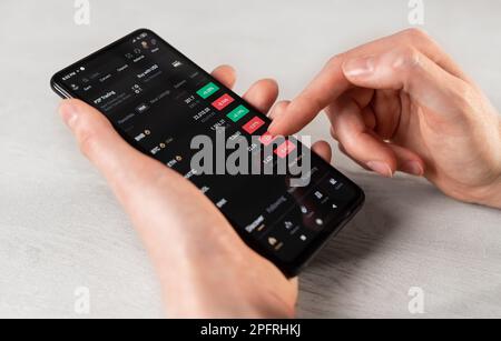 Lodz, Polen Februar 07 2023 Hands use mobile phone, Financial Binance App, Finance Application for Cryptocurrency Exchange, Crypto seeling, buy, Stockfoto